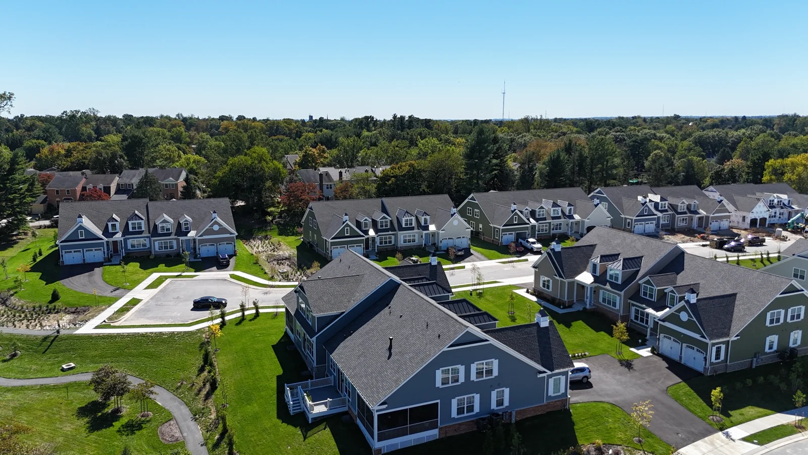 Aerial view of carriage-home roofs, porches and the community streetscape