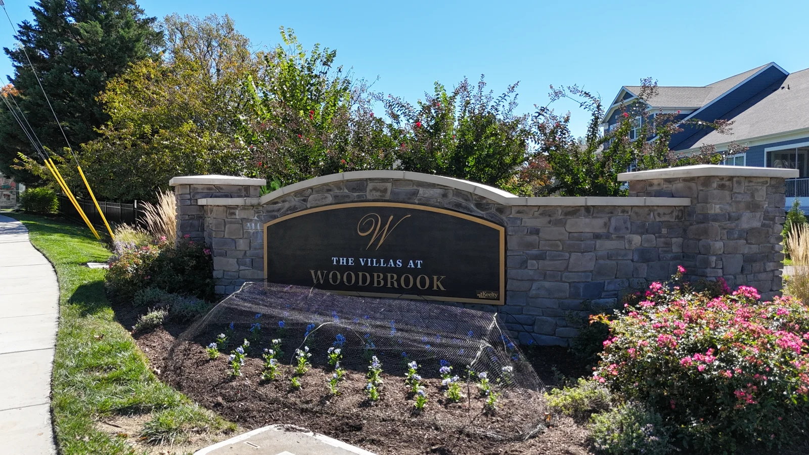 The Villas at Woodbrook stone entrance sign and landscaping