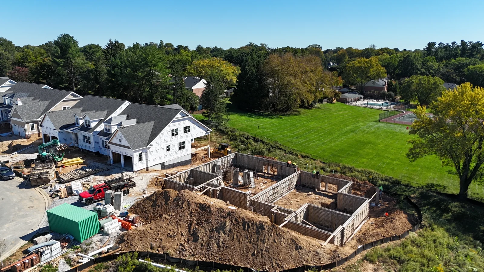 Foundations, construction equipment and homes in progress
